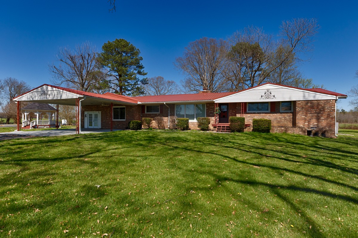 24 Slaughter Pen Road Ardmore, TN 38449 - Photo 1 of 32 a front view of a house with a yard table and chairs