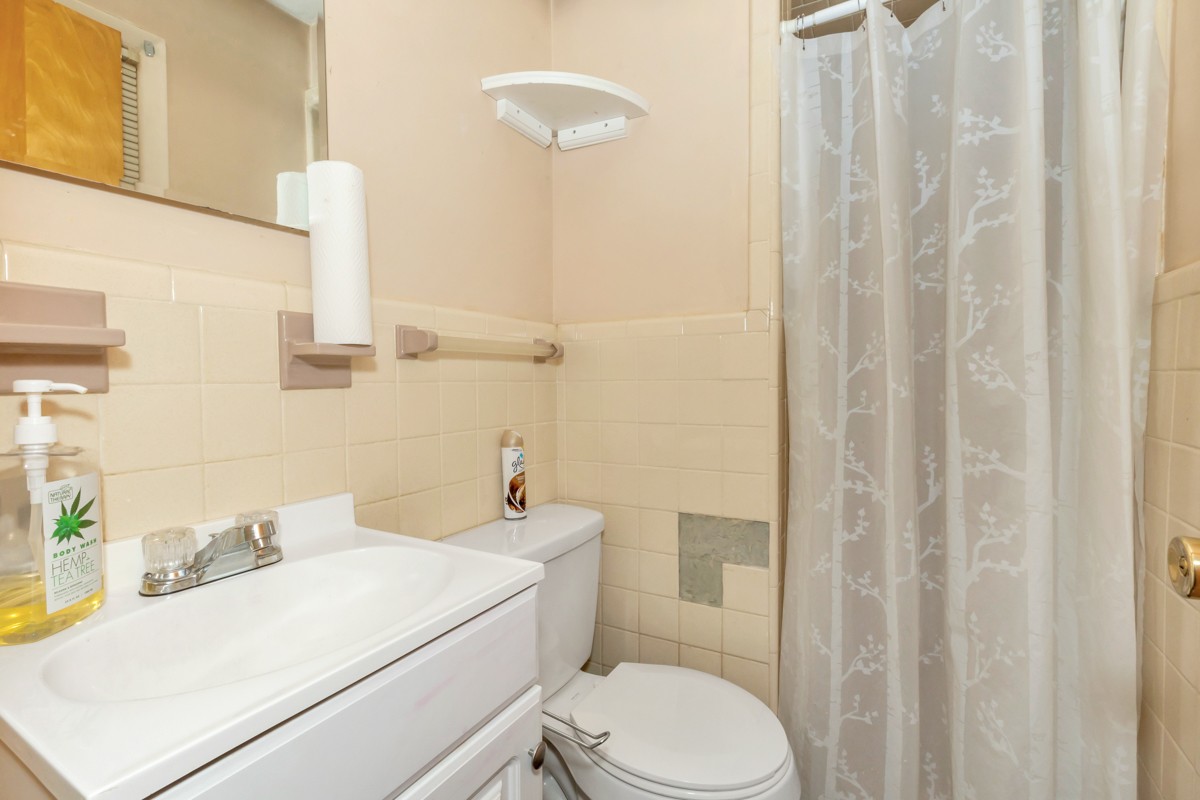 24 Slaughter Pen Road Ardmore, TN 38449 - Photo 14 of 32 a bathroom with a sink a toilet and shower curtain