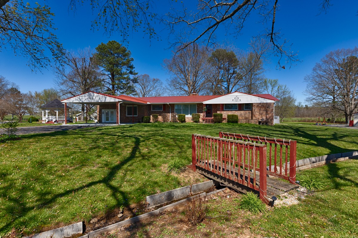 24 Slaughter Pen Road Ardmore, TN 38449 - Photo 29 of 32 a view of a house with a yard fire pit and furniture