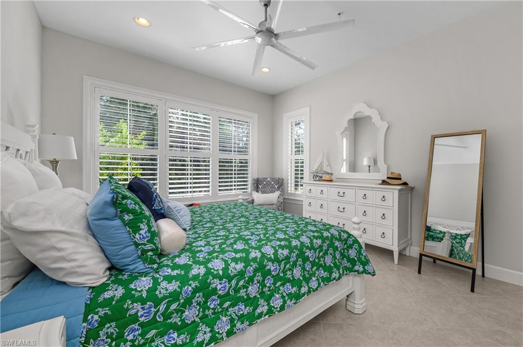 6552 Dominica Drive, Unit 101 Naples, FL 34113 - Photo 15 of 50 a bedroom with a bed mirror and window