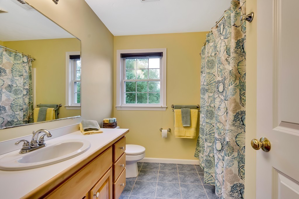 11 Pennock Road Ashland, MA 01721 - Photo 21 of 30 a bathroom with a sink a toilet and shower curtain