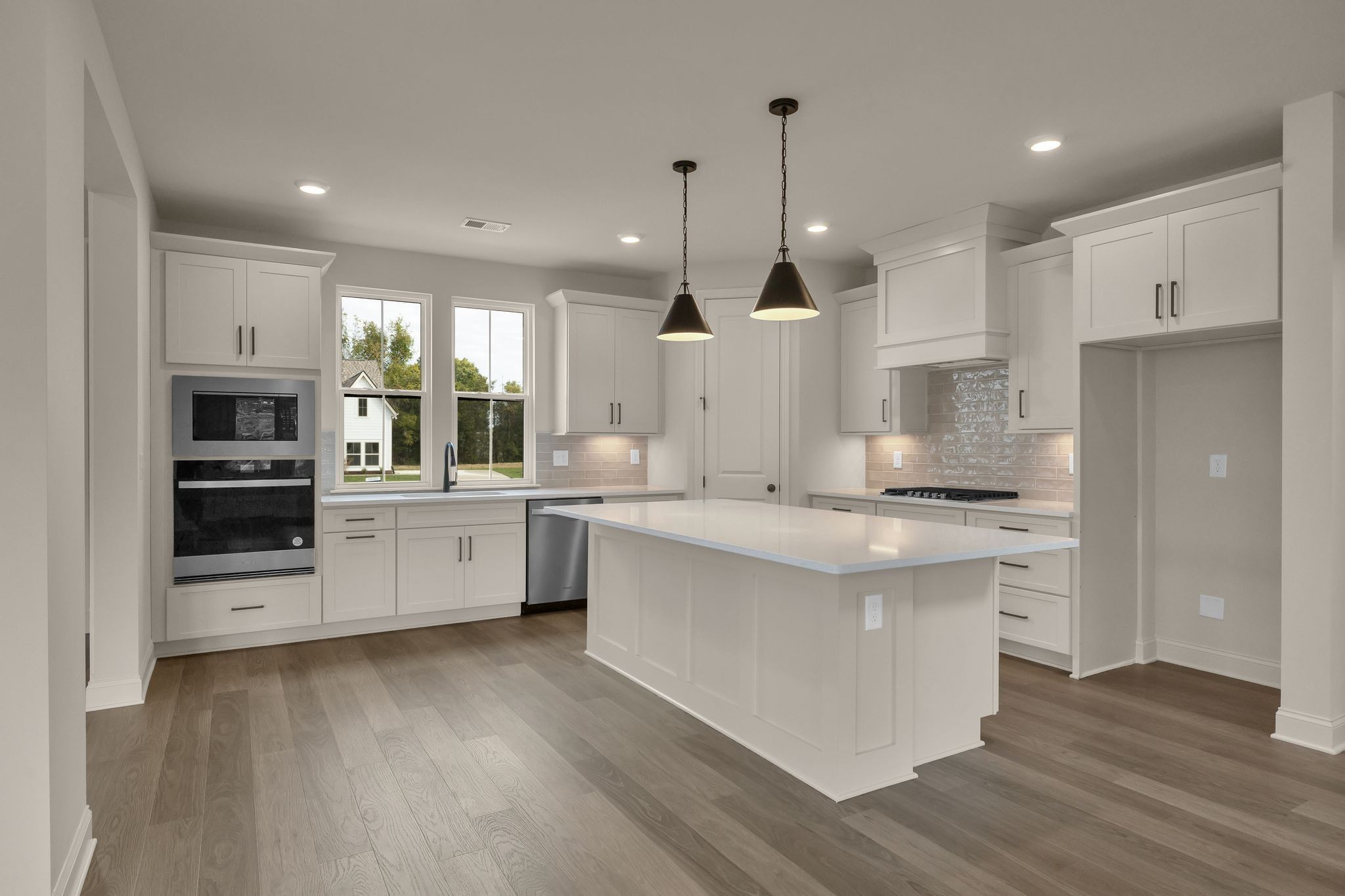 7321 Winners Road Murfreesboro, TN 37129 - Photo 15 of 41 a kitchen with stainless steel appliances kitchen island granite countertop a stove a sink a refrigerator and white cabinets with wooden floor