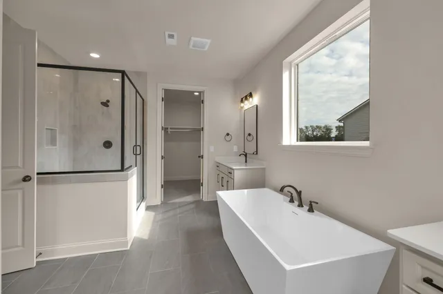 a bathroom with a bathtub and a sink