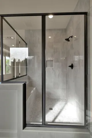 a bathroom with a glass shower door