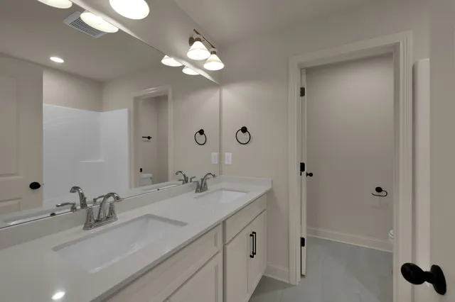 a bathroom with a sink vanity and mirror