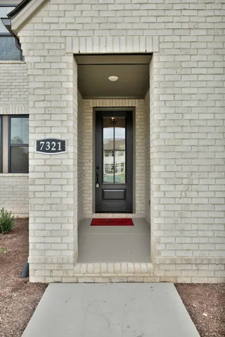 a front view of a house with a white door