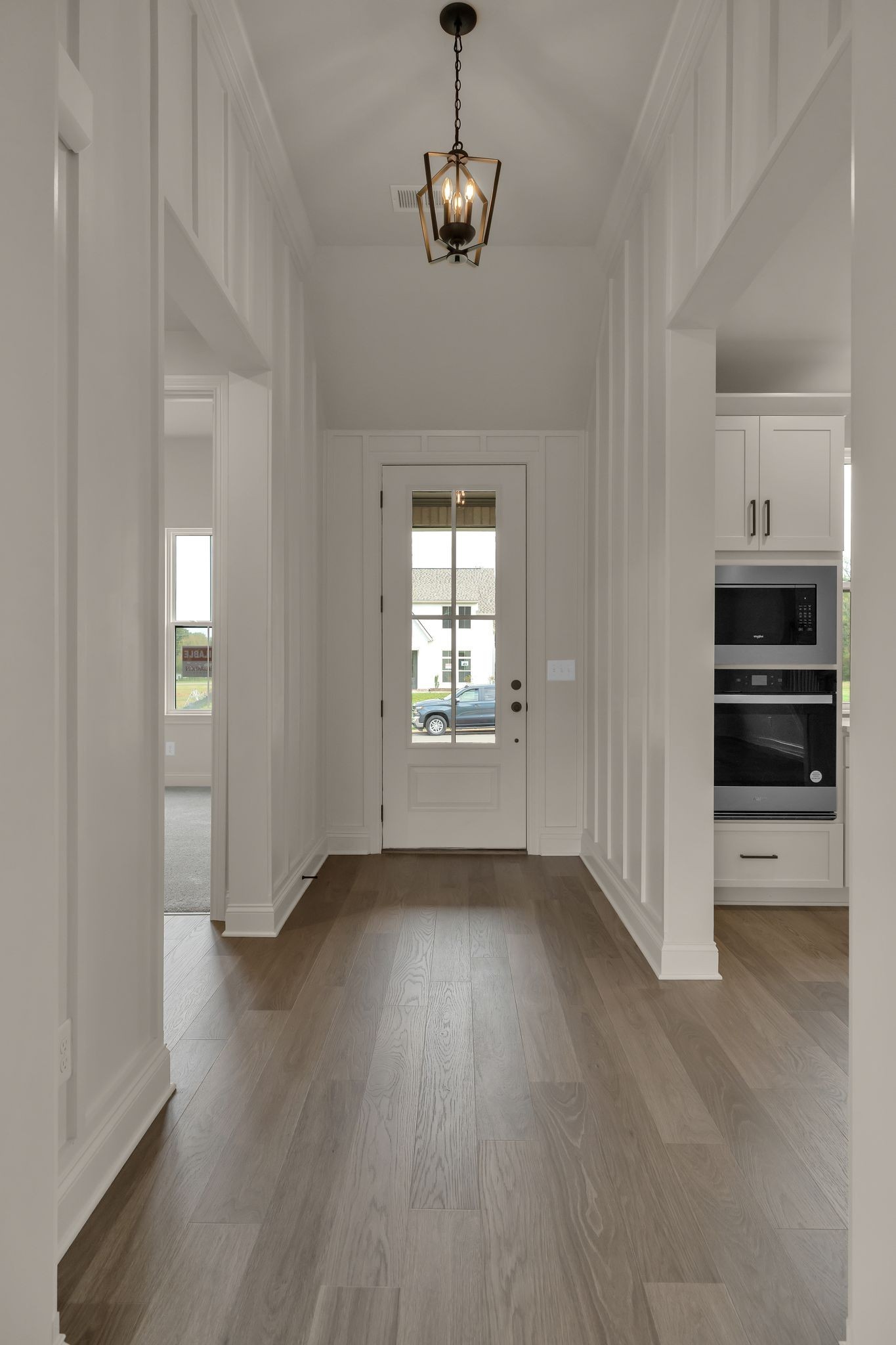 7321 Winners Road Murfreesboro, TN 37129 - Photo 7 of 41 an empty room with wooden floor cabinet and windows