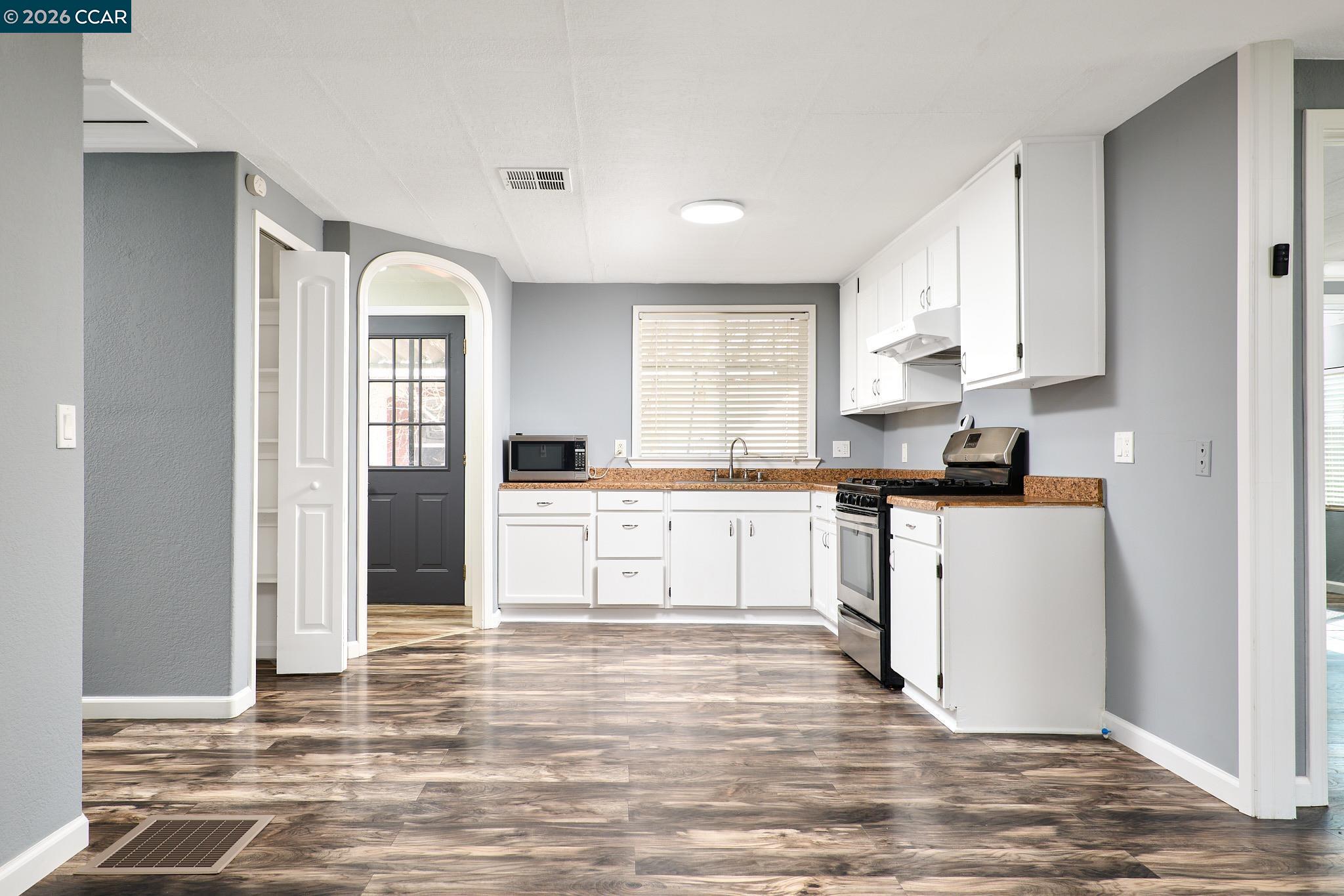 16711 Marsh Creek Road, Unit 112 Clayton, CA 94517 - Photo 11 of 27 a kitchen with granite countertop white cabinets and white appliances