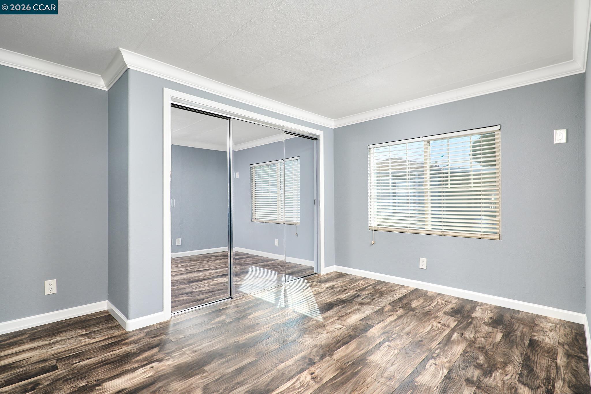 16711 Marsh Creek Road, Unit 112 Clayton, CA 94517 - Photo 18 of 27 a view of an empty room with wooden floor and a window