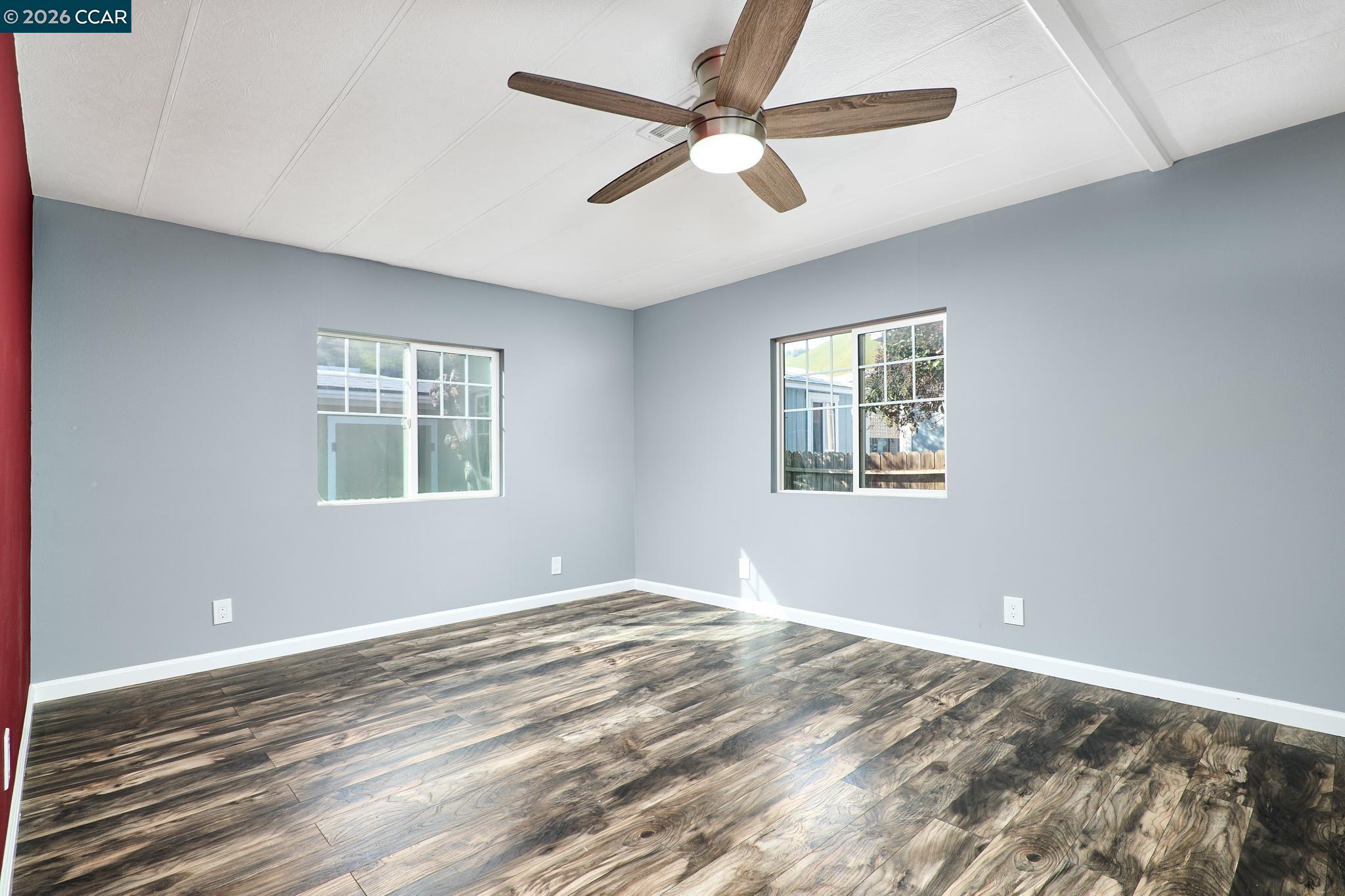 16711 Marsh Creek Road, Unit 112 Clayton, CA 94517 - Photo 20 of 27 a view of a big room with windows and ceiling fan