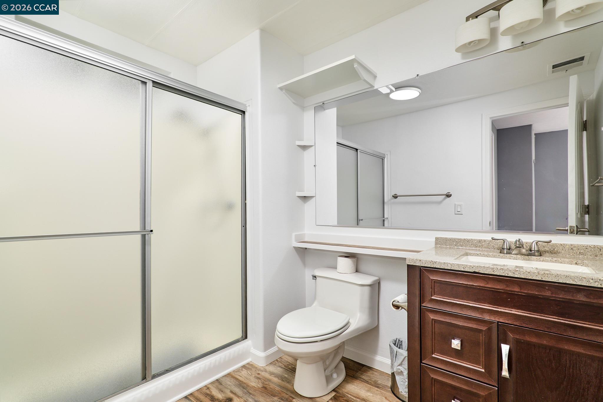 16711 Marsh Creek Road, Unit 112 Clayton, CA 94517 - Photo 22 of 27 a bathroom with a sink a toilet a mirror and shower