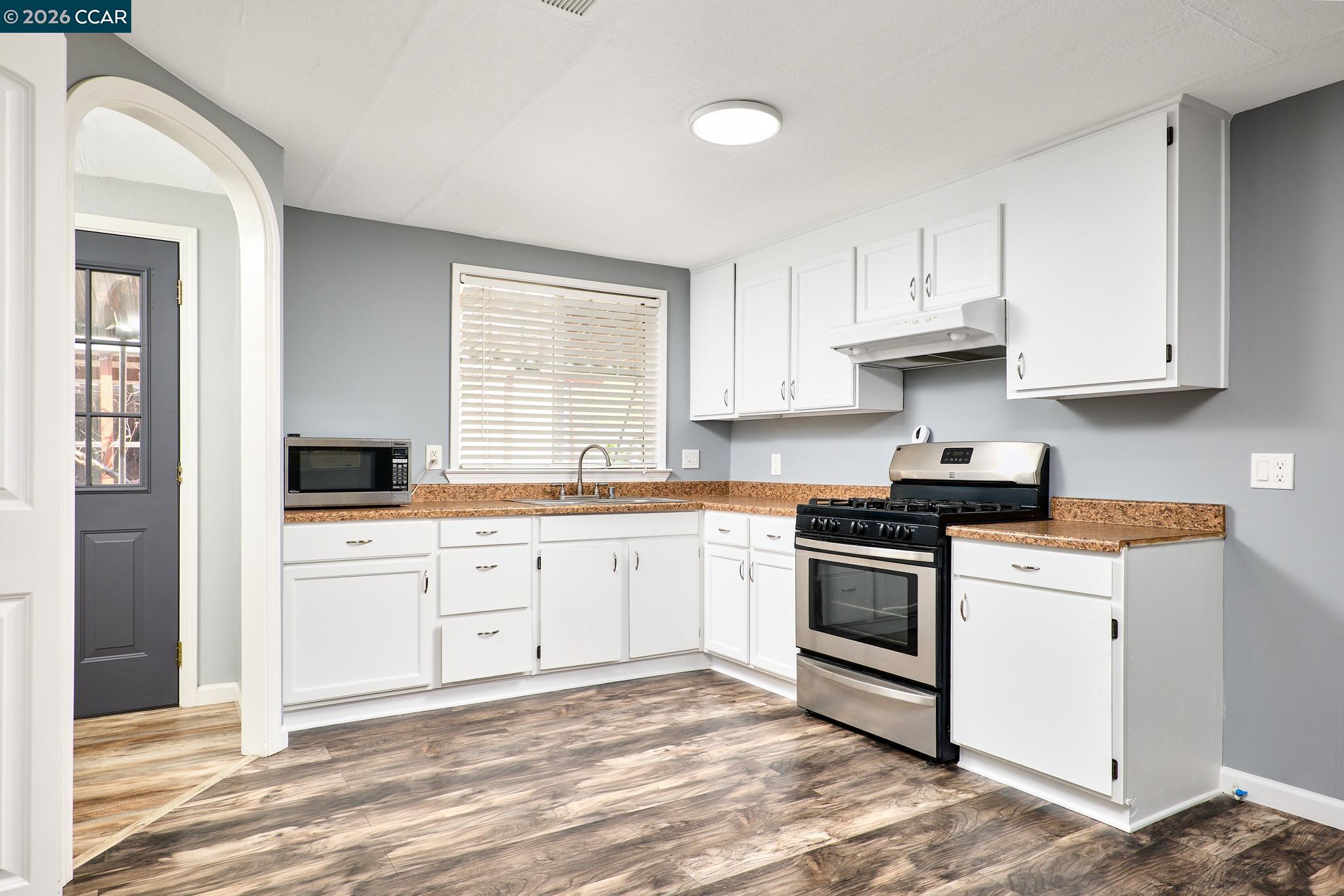 16711 Marsh Creek Road, Unit 112 Clayton, CA 94517 - Photo 9 of 27 a kitchen with granite countertop white cabinets and appliances