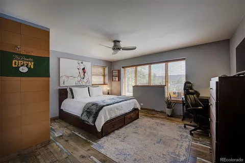 a bedroom with a bed and a desk