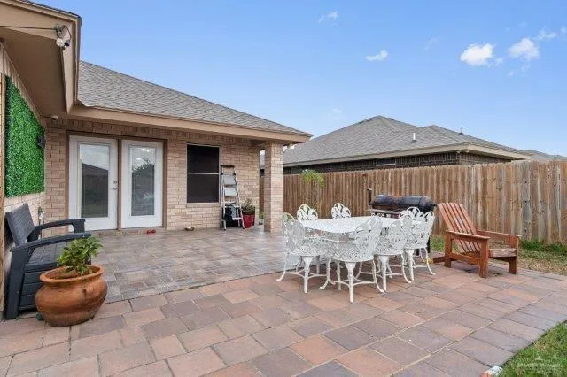 a view of a patio with table and chairs and potted plants