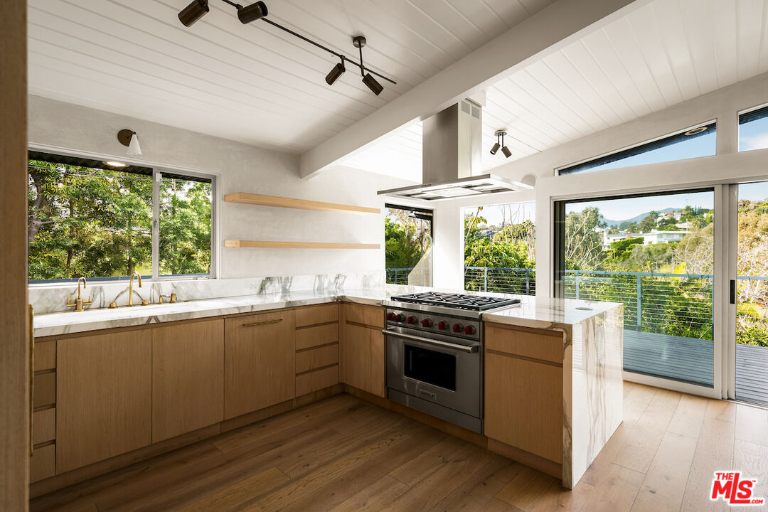 295 Mabery Road Santa Monica, CA 90402 - Photo 13 of 49 a kitchen with stainless steel appliances granite countertop a stove and a sink