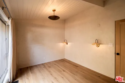 a large white kitchen with a large window
