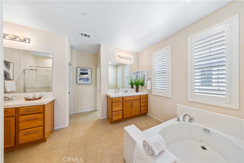 130 Prospect Irvine, CA 92618 - Photo 22 of 35 a bathroom with a tub sink and mirror