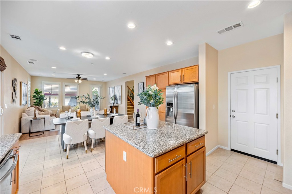 130 Prospect Irvine, CA 92618 - Photo 9 of 35 a kitchen with stainless steel appliances granite countertop a table and chairs in it