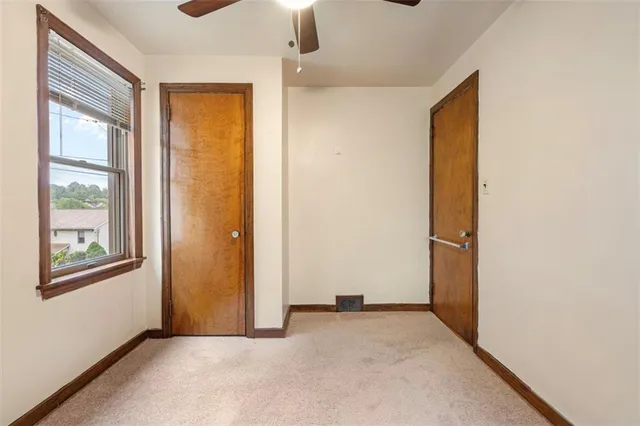 an empty room with windows and closet