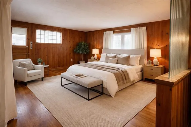 a bedroom with a bed couch and window