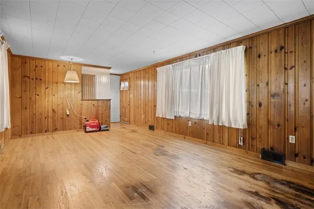 a view of an empty room with a fireplace and a window