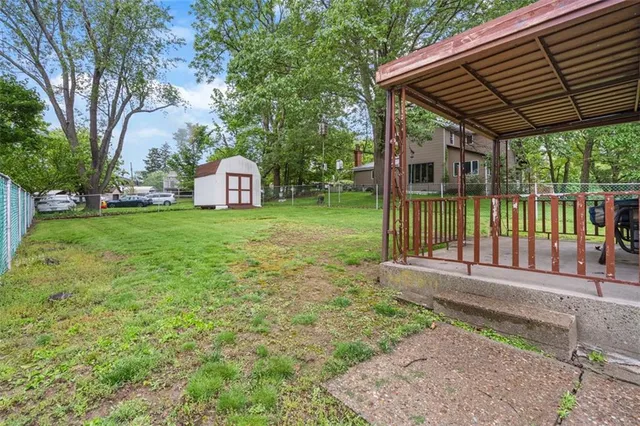 a porch with a yard table and chairs