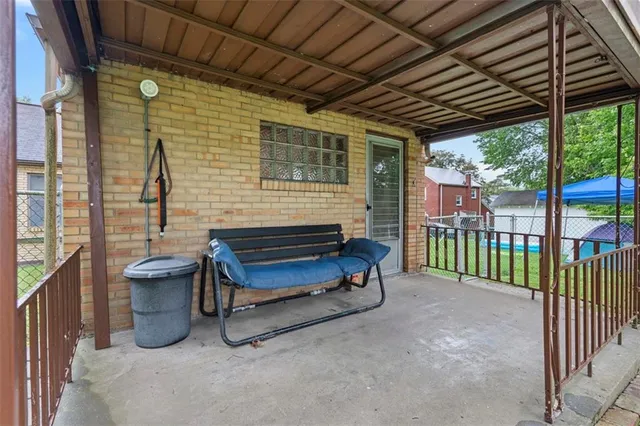 a view of a patio with a table and chairs