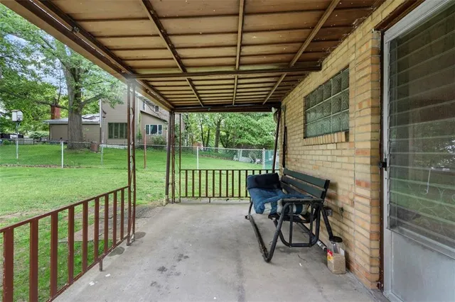 a view of a porch with furniture and garden