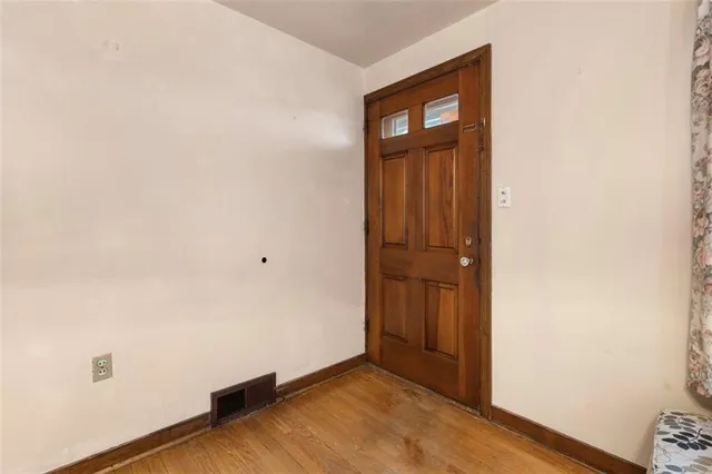 an empty room with wooden floor