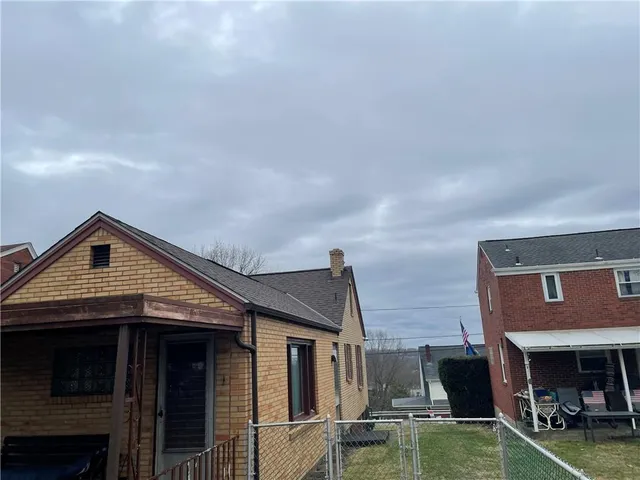 a view of a house with a barbeque and a fireplace