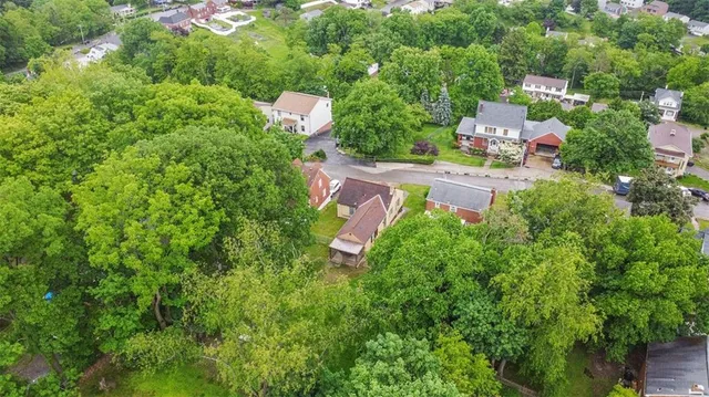 a view of a house with a yard and green space