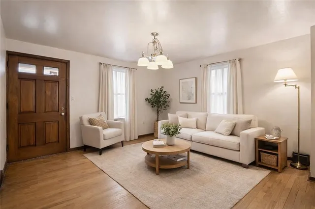 a living room with furniture and a chandelier