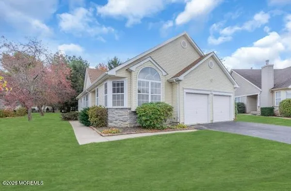 a front view of a house with a garden and yard