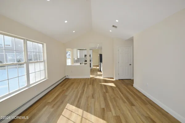 an empty room with furniture and windows