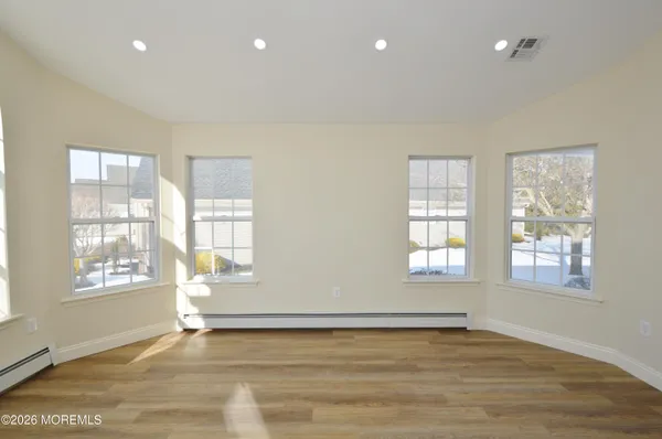 a view of a hallway with wooden floor