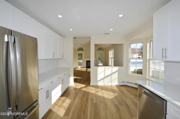 a kitchen with stainless steel appliances a refrigerator stove microwave and cabinets