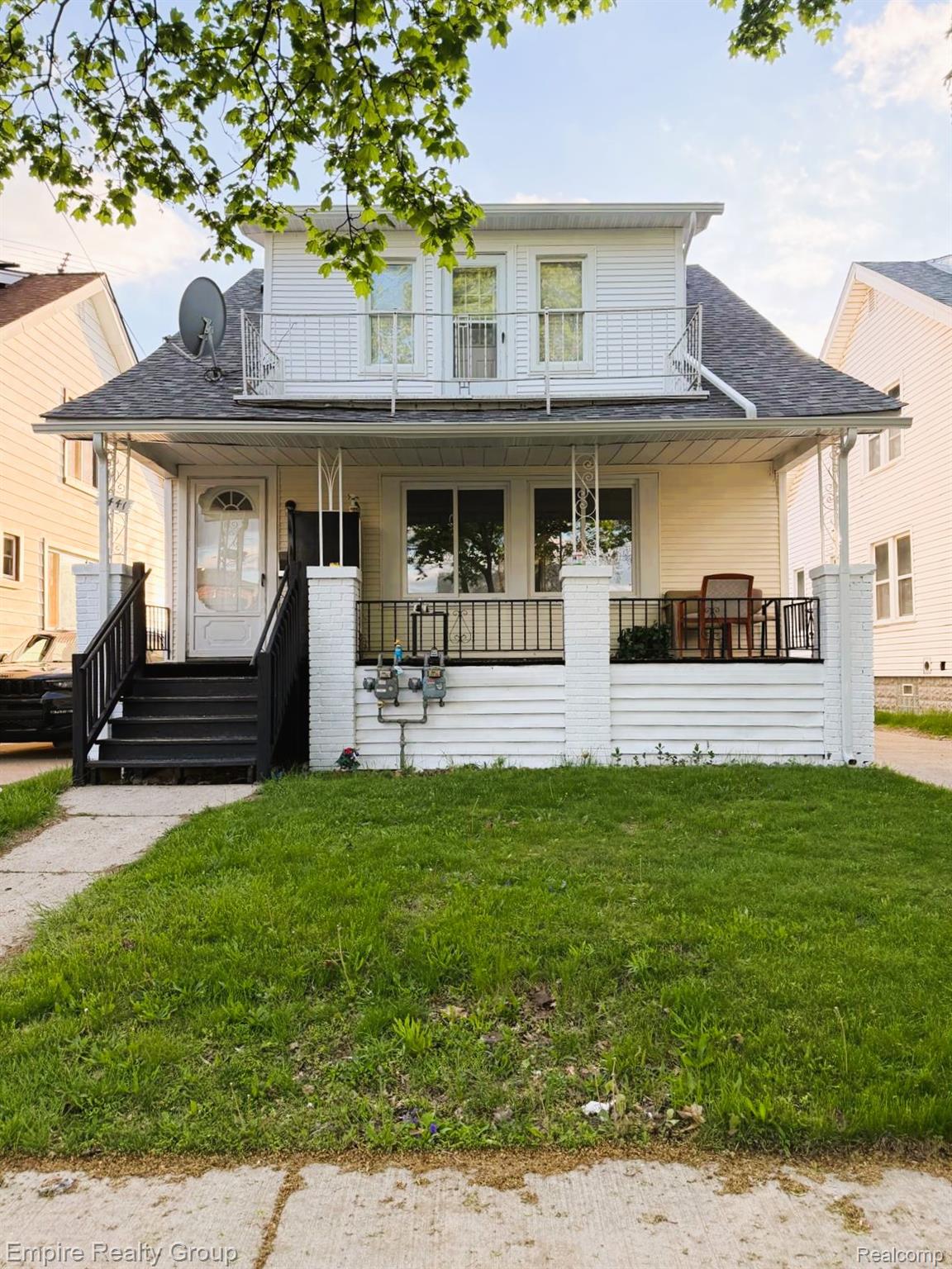 6441 Appoline Street, Unit 1 Dearborn, MI 48126 - Photo 2 of 13 View of front of property featuring a front yard, a shingled roof, and a porch