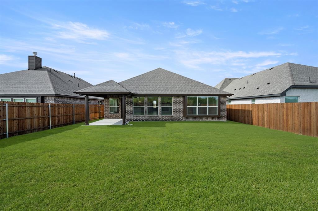 10809 Rothland Street Crowley, TX 76036 - Photo 29 of 30 a front view of a house with a garden
