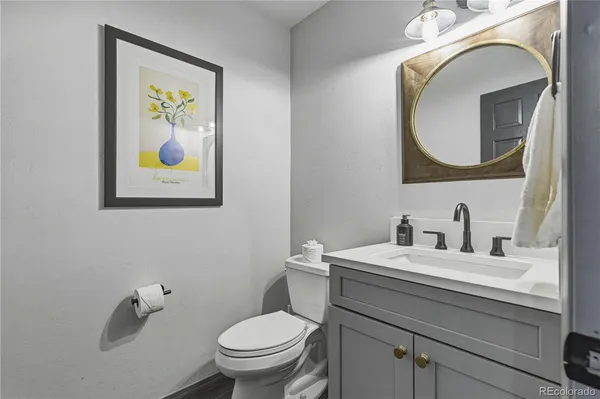 a bathroom with a toilet a sink and mirror