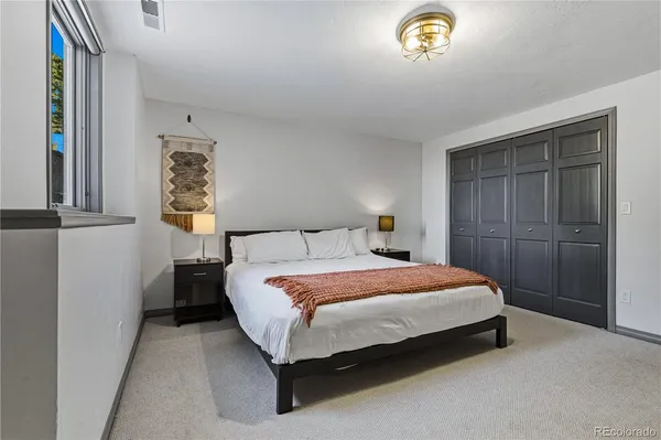 a bedroom with a bed and a window