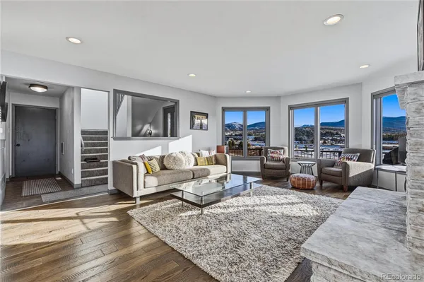 a living room with furniture wooden floor and a view of kitchen