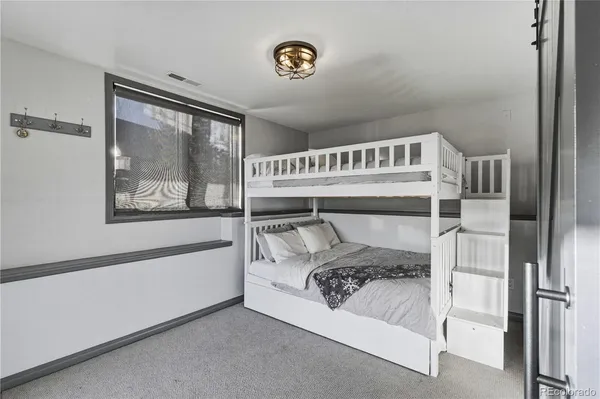 a bedroom with a large bed and a window