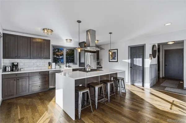 a open kitchen with stainless steel appliances granite countertop a lot of counter space and wooden floor