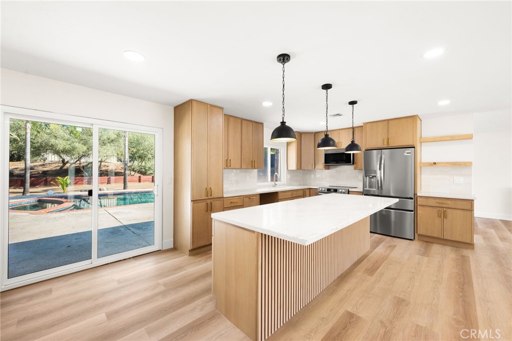2060 South Grade Road Alpine, CA 91901 - Photo 12 of 69 a large kitchen with kitchen island a large counter top a sink a stove and wooden floors