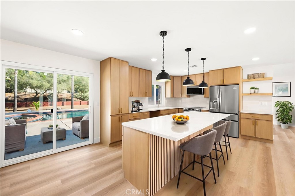 2060 South Grade Road Alpine, CA 91901 - Photo 13 of 69 a kitchen with stainless steel appliances granite countertop a table chairs and a refrigerator