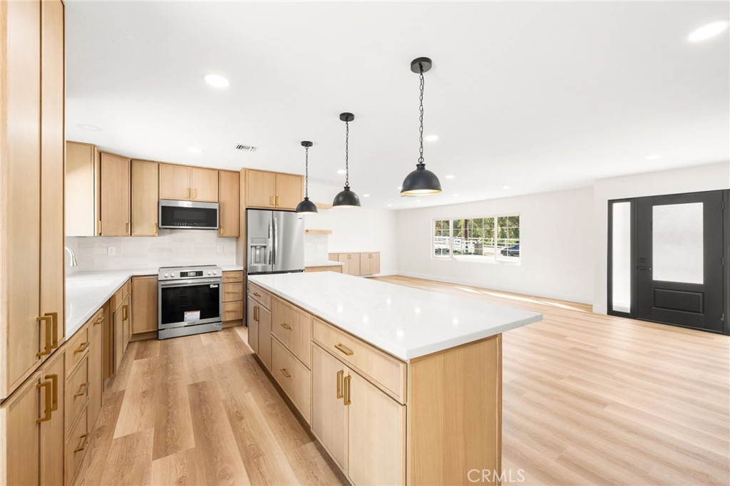 2060 South Grade Road Alpine, CA 91901 - Photo 15 of 69 a kitchen with stainless steel appliances granite countertop a sink a oven a stove and a wooden floors