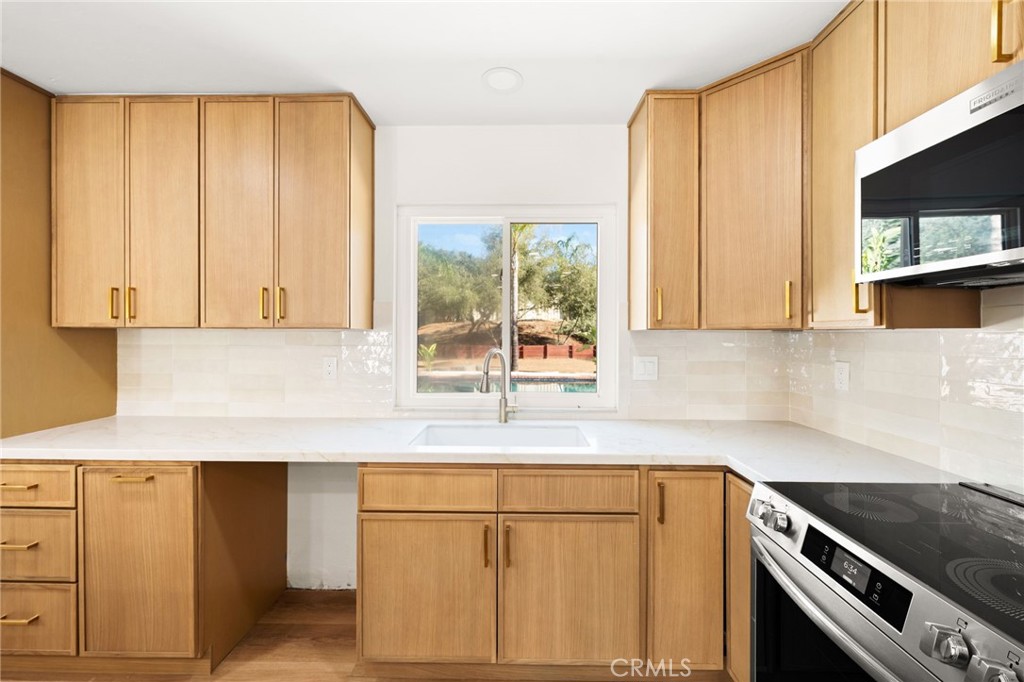 2060 South Grade Road Alpine, CA 91901 - Photo 16 of 69 a kitchen with granite countertop cabinets stainless steel appliances and a sink