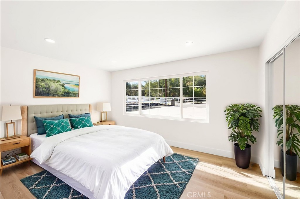 2060 South Grade Road Alpine, CA 91901 - Photo 39 of 69 a bedroom with a large bed and a potted plant