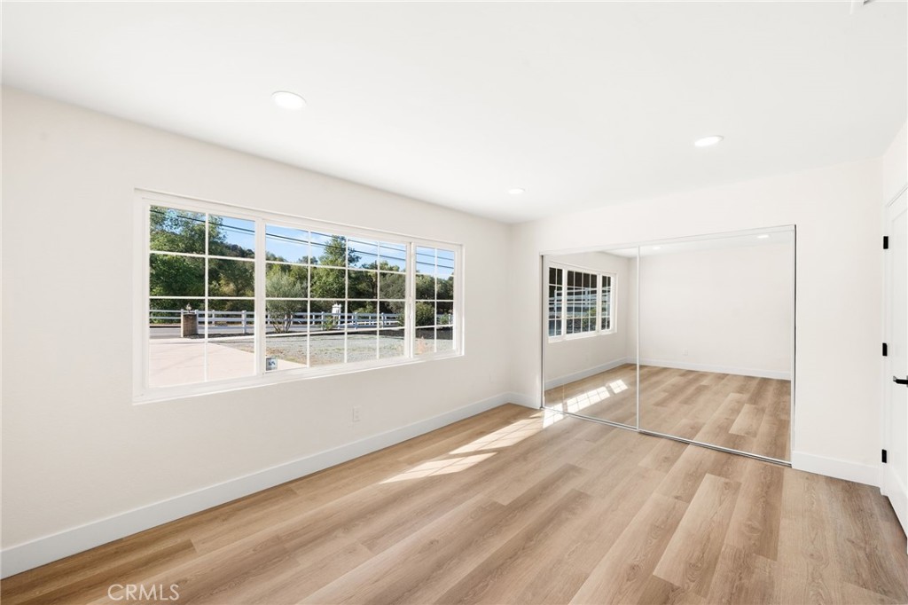 2060 South Grade Road Alpine, CA 91901 - Photo 40 of 69 an empty room with wooden floor and windows