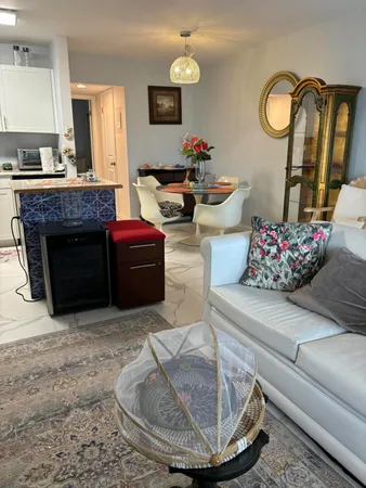 a living room with furniture flowerpot and window